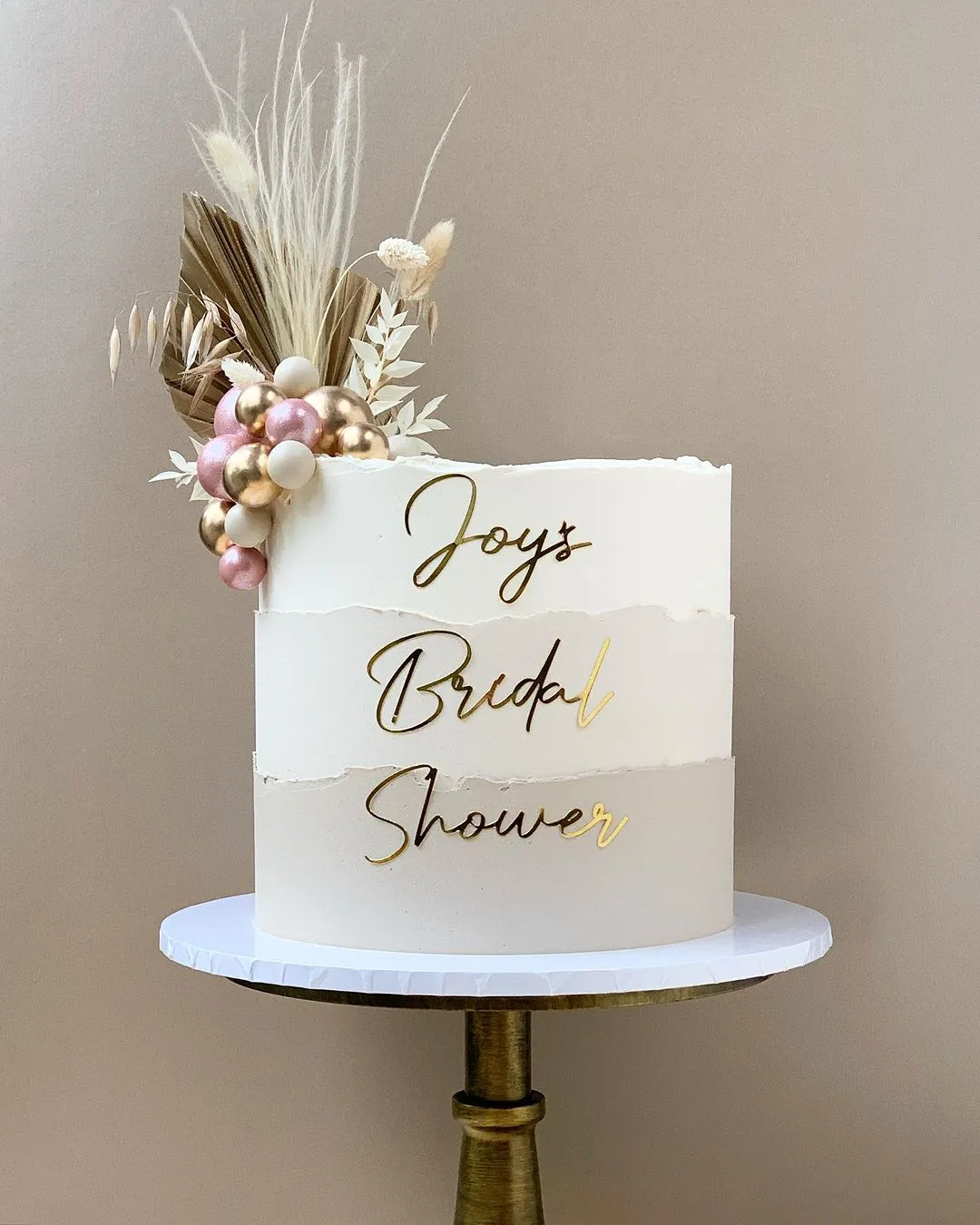 single cake with layered colors and simple bridal shower writing